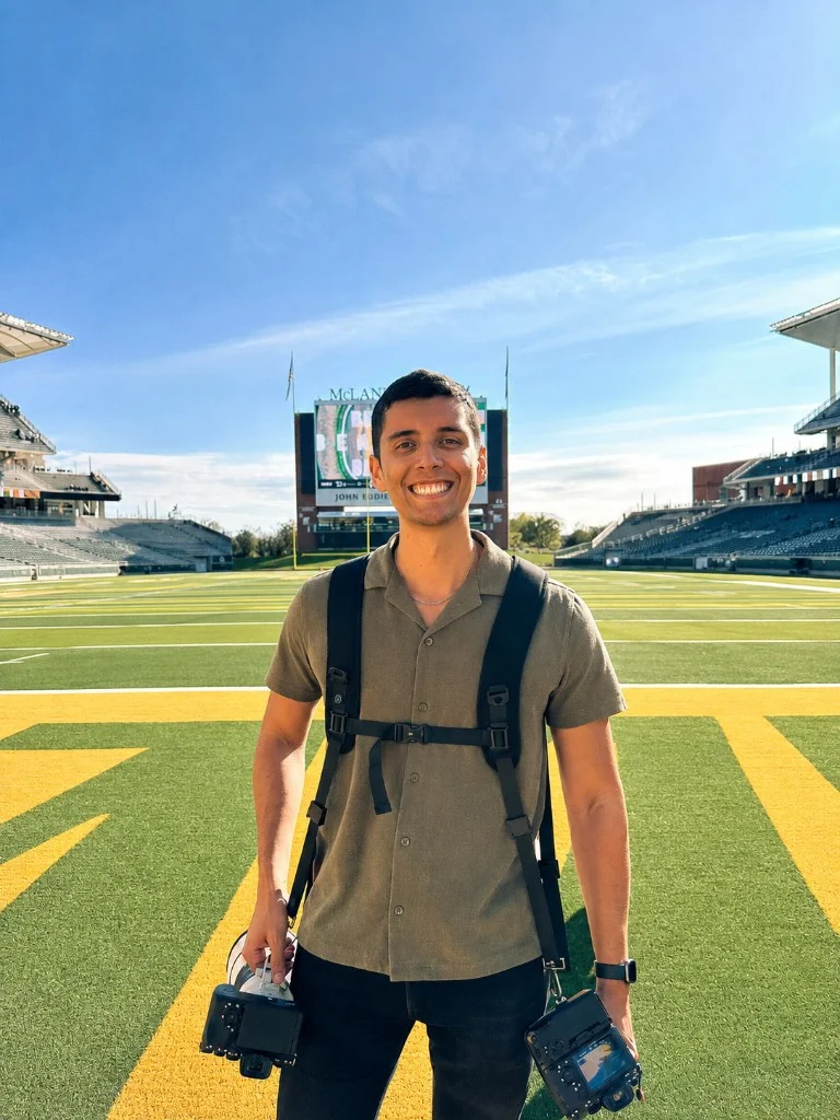 Josh McSwain with professional camera gear on the field